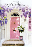 A romantic entrance scene unfolds as if on a peaceful residential street near Oakleigh Park in Whetstone, where a pastel pink front door glows softly in gentle daylight. The door sits within a whitewashed wall that reflects the sun in a muted, calming way, with a simple shutter painted in a coordinating blush shade to create a balanced, harmonious façade. Above, generous sprays of lavender wisteria spill down in cascading clusters, their tiny blossoms forming a dreamy canopy over the doorway. Each stem bends gracefully, creating the impression of a floral curtain through which light filters, bathing the steps and door in dappled, lilac-tinged shadows. At the threshold, a florist's tin bucket in understated grey holds an abundant bouquet of white and cream roses, each bloom lush and full, their soft petals packed in layered spirals. Sprigs of gentle green foliage weave between the roses, giving depth, texture, and a touch of the garden to the composition. Around the base of the bucket, a pale pink ribbon is tied neatly, its satin tails resting lightly against the step like a small, thoughtfully placed detail. The arrangement feels both elegant and relaxed, the sort of housewarming floral delivery that might arrive from a trusted Whetstone florist to celebrate a new flat or family home. The atmosphere is tender and filled with quiet promise: soft colours, imagined fragrance, and an unspoken message of welcome. It suggests congratulations on a new address, a comforting gesture during a life change, or a simple way to say, Your new home is already loved.